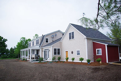 Large traditional beige two-story wood exterior home idea in Burlington with a shingle roof