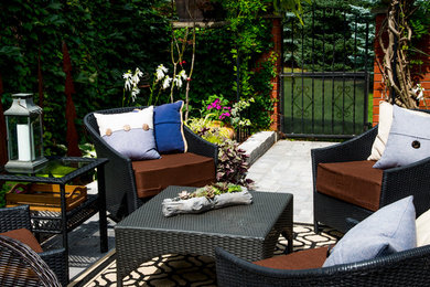 Mid-sized mountain style side yard concrete paver patio photo in Toronto with no cover