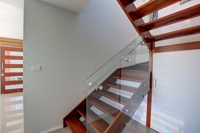 Design ideas for a mid-sized modern wood u-shaped staircase in Sydney with wood risers.