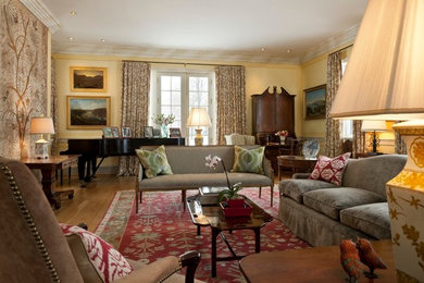 Living room - large open concept light wood floor living room idea in Baltimore with a music area and yellow walls