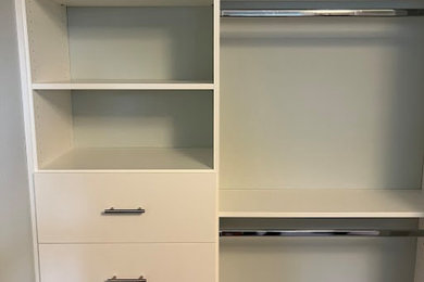 Example of a small minimalist reach-in closet design in Seattle