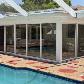 Full installation of custom impact-rated sliding glass doors patio enclosure
