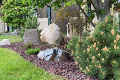 Photo of a mid-sized drought-tolerant and rock front yard landscaping in Edmonton.