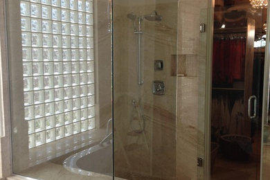 Inspiration for a mid-sized timeless master beige tile and limestone tile limestone floor and beige floor bathroom remodel in Phoenix with beige walls, a hinged shower door and a two-piece toilet