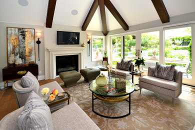 Living room - mid-sized transitional open concept medium tone wood floor and brown floor living room idea in Dallas with gray walls, a standard fireplace, a concrete fireplace and a wall-mounted tv