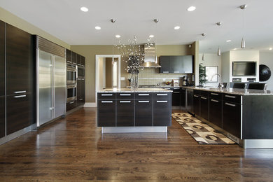 Open concept kitchen - large modern u-shaped medium tone wood floor and brown floor open concept kitchen idea in San Francisco with an undermount sink, flat-panel cabinets, brown cabinets, granite countertops, beige backsplash, ceramic backsplash, stainless steel appliances and an island