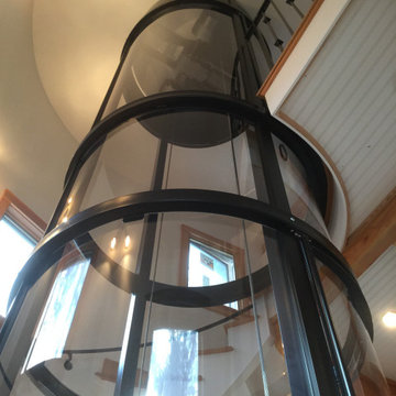 Round Acrylic Home Elevator Incorporated into Staircase