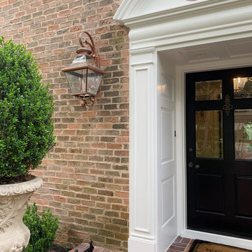Traditional Brick Classic Home with White Trim and Black Shutters