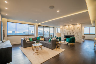 Trendy open concept dark wood floor, brown floor and tray ceiling living room photo in Houston with a stone fireplace