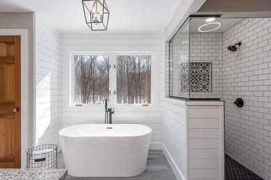 Large farmhouse master porcelain tile and shiplap wall bathroom photo with an undermount sink, granite countertops, a niche, white cabinets and a built-in vanity
