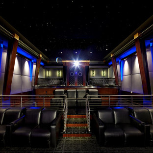 Design ideas for an expansive modern enclosed home cinema in New York with grey walls, black floors, ceramic flooring and a projector screen.