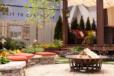 Example of a mid-sized classic backyard brick patio design in Cincinnati with a pergola