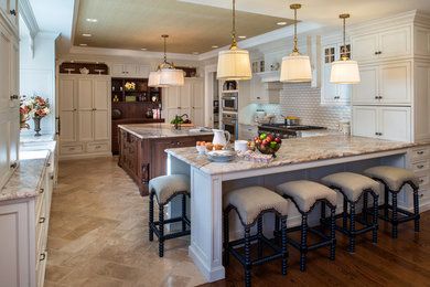 Eat-in kitchen - large transitional u-shaped eat-in kitchen idea in New York with a farmhouse sink, shaker cabinets, granite countertops, beige backsplash, stainless steel appliances, an island and beige cabinets