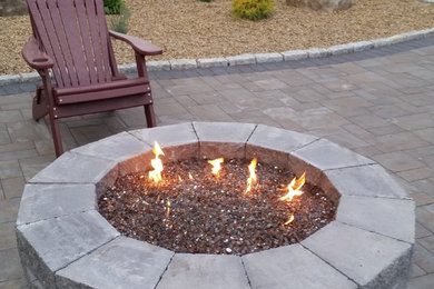 Photo of a mid-sized transitional partial sun backyard stone landscaping in Boston for spring.