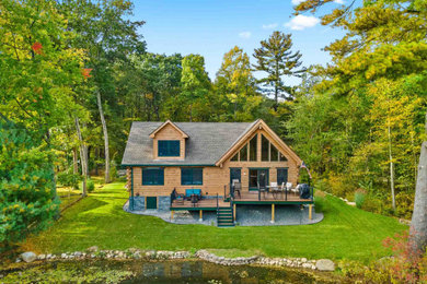 Example of a mid-sized mountain style brown two-story wood house exterior design in Providence with a shingle roof and a gray roof