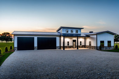 Inspiration for a large cottage attached three-car garage workshop remodel in Dallas