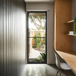 Design ideas for a beach style home office in Geelong with white walls, a built-in desk and grey floor.