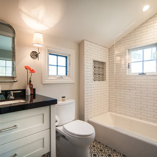 Inspiration for a mid-sized victorian white tile and subway tile ceramic floor and multicolored floor bathroom remodel in San Francisco with shaker cabinets, white cabinets, a two-piece toilet, white walls, an undermount sink, onyx countertops and a hinged shower door