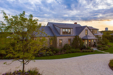 Example of a large beach style brown two-story wood gable roof design in Boston