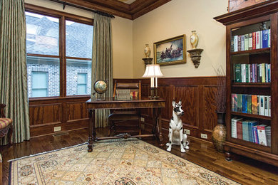 Mid-sized elegant freestanding desk dark wood floor study room photo in Other with beige walls
