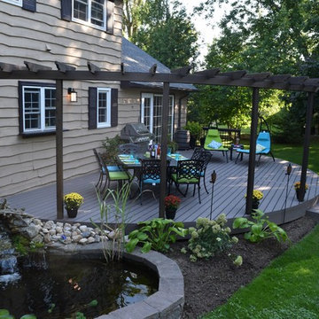 A curved Geo deck with cedar pergola.