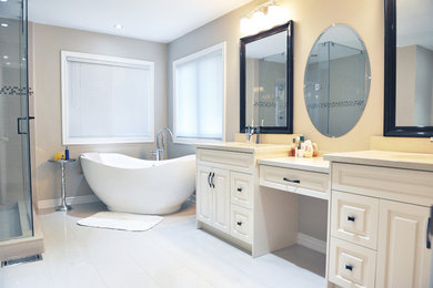 Inspiration for a mid-sized transitional master gray tile and stone tile ceramic tile bathroom remodel in Toronto with recessed-panel cabinets, white cabinets, a two-piece toilet, beige walls, an undermount sink and marble countertops