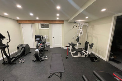 Mid-sized urban black floor and exposed beam multiuse home gym photo in Montreal with green walls