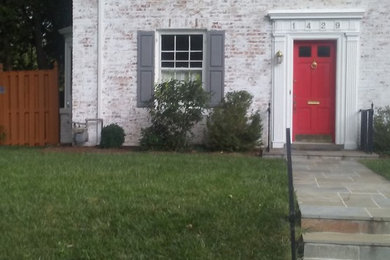 Trendy white one-story house exterior photo in DC Metro with a shingle roof