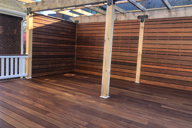 Deck - mid-sized contemporary backyard second story privacy and wood railing deck idea in Nashville with a pergola