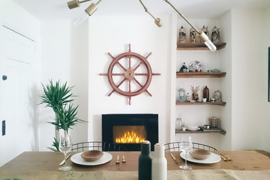 Mid-sized danish kitchen/dining room combo photo in Toronto with white walls and a standard fireplace