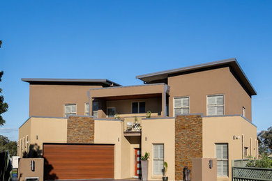 Photo of a large contemporary two-storey exterior in Newcastle - Maitland.