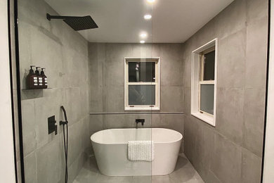 Imagen de cuarto de baño principal moderno grande con armarios tipo vitrina, bañera exenta, ducha abierta y ducha con puerta corredera