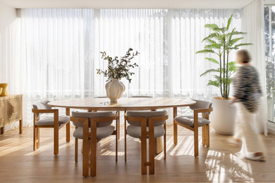 Dining room - contemporary medium tone wood floor and brown floor dining room idea in Melbourne with white walls
