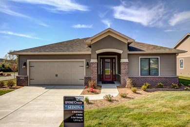 Small elegant beige one-story mixed siding gable roof photo in Chicago