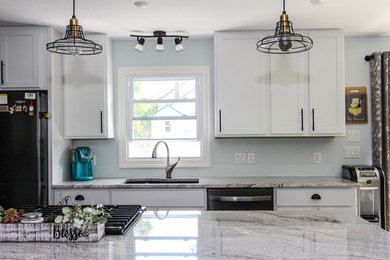 Inspiration for a mid-sized transitional single-wall laminate floor and brown floor open concept kitchen remodel in Minneapolis with an undermount sink, shaker cabinets, gray cabinets, granite countertops, stainless steel appliances, an island and gray countertops