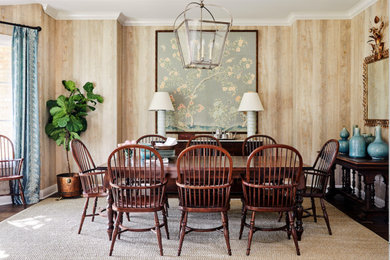 This is an example of a traditional dining room in Austin with beige walls, dark hardwood floors and brown floor.