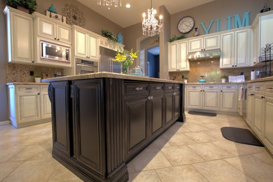 Example of a large cottage chic ceramic tile eat-in kitchen design in Phoenix with white cabinets, stainless steel appliances and an island