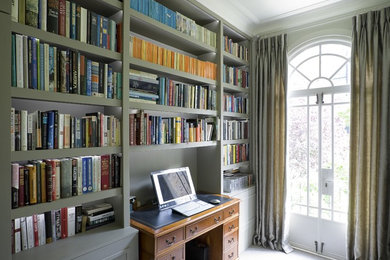 Large modern study room in London with grey walls, carpet and a freestanding desk.