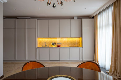 This is an example of a contemporary kitchen in Moscow with white cabinets, no island and beige floor.