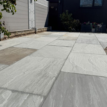 Grey Riven Paving Run Up to a Black Clad Lodge