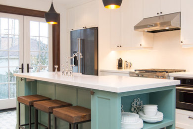 Inspiration for a mid-sized transitional u-shaped ceramic tile eat-in kitchen remodel in Toronto with flat-panel cabinets, white cabinets, quartz countertops, white backsplash, glass tile backsplash, stainless steel appliances and an island