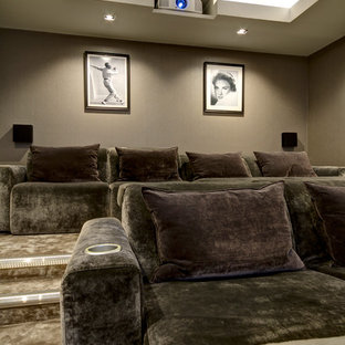 Photo of a large contemporary enclosed home cinema in Kent with brown walls, carpet, a projector screen and beige floors.