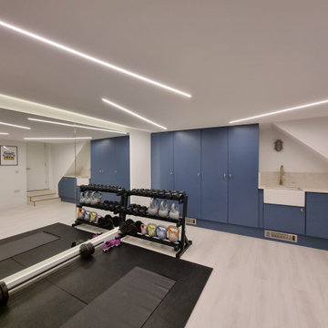 Home gym with integrated utilities room