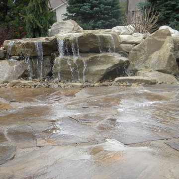 Carved stone water feature pondless and stone patio
