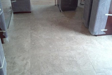 Photo of a kitchen in New York with medium wood cabinets and ceramic floors.