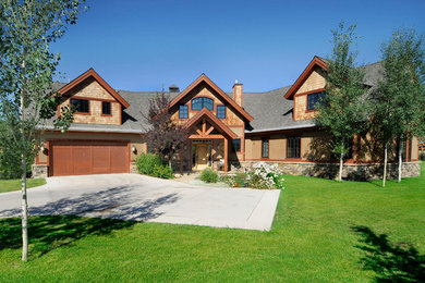 Large transitional brown two-story mixed siding exterior home photo in Other