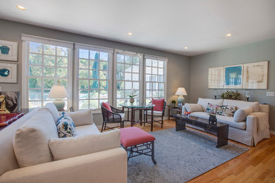 Living room - large transitional open concept medium tone wood floor living room idea in Los Angeles with blue walls, no fireplace and no tv