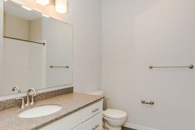 Mid-sized trendy vinyl floor bathroom photo in Other with shaker cabinets, white cabinets, quartzite countertops and gray walls