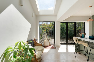 Large modern conservatory in Other with travertine flooring and beige floors.