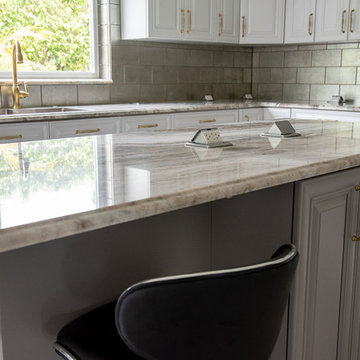 Transitional Kitchen Done in a 2 Tone Color With Integrated Dining Table